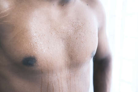 young man skin sweating in chests .の写真素材