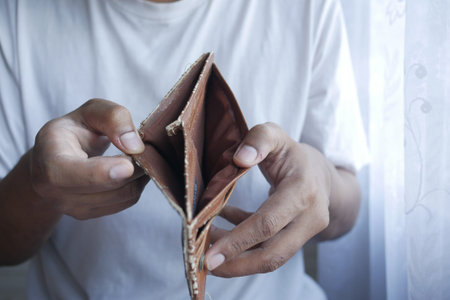 Man hand open an empty wallet with copy space.