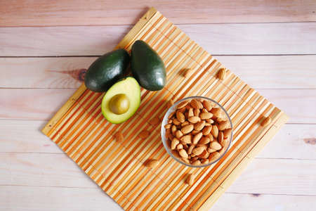 top view of avocado and almond nut on tableの写真素材