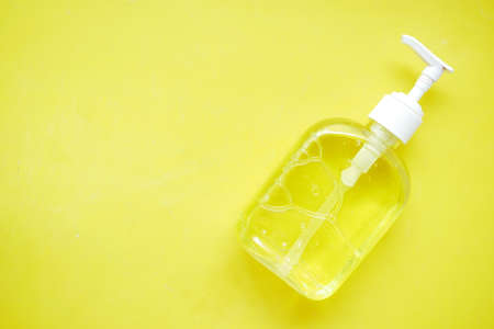 hand sanitizers yellow background close upの写真素材