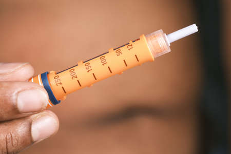 young man hand using insulin pen close upの写真素材