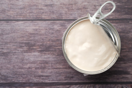 top view of milk cream in a container on wooden background,の写真素材