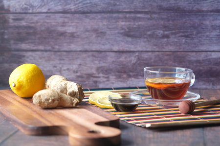 green tea with ginger, lemon and honey on wooden background.