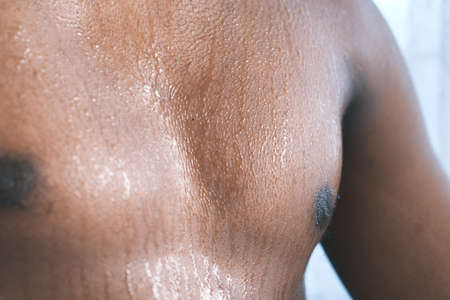 young man skin sweating in chests .の写真素材