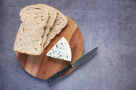 top view of blue cheese ,and slice of brown bread on table