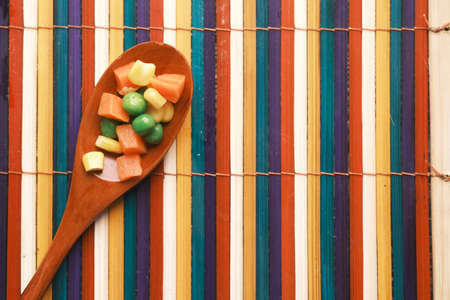 close up of corn, carrot and beans on a spoonの写真素材