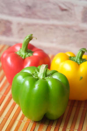 Yellow orange and red capsicum on white backgroundの写真素材