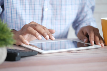 businessman using digital tablet on office desk