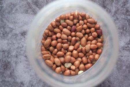 Processed pea nuts in a bowl on table top down .