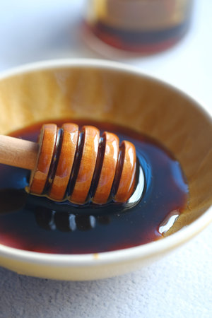 close up of fresh honey with spoon on tableの写真素材