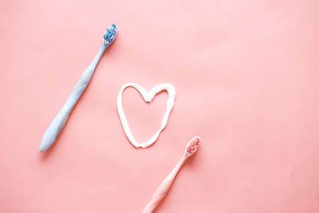 tooth brush and paste on pink backgroundの写真素材