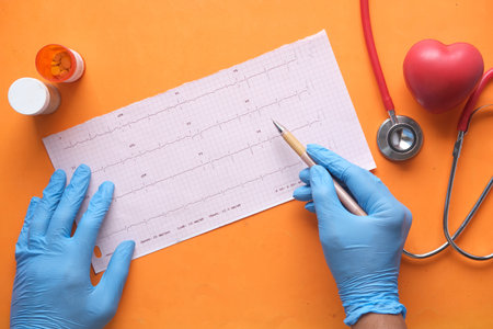 doctor hand in medical gloves analyzing cardio diagram.