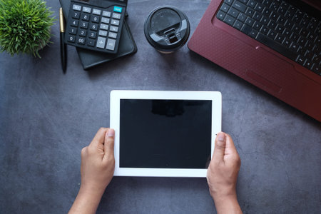 top view of businessman using digital tablet on office desk