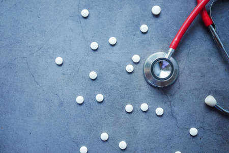 medical pills and stethoscope on black backgroundの写真素材