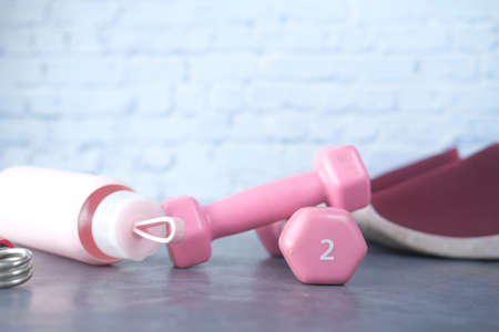 pink color dumbbell, exercise mat and water bottle on white backgroundの写真素材