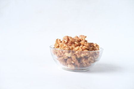 a bowl of walnut on white backgroundの写真素材