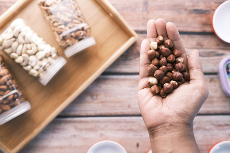 top view of hazelnuts on palm of hand