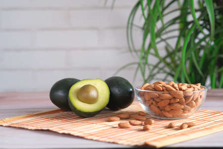 close up of slice of avocado and mixed nut on chopping board.の写真素材
