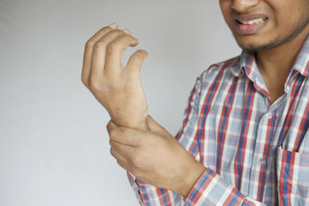 man suffering pain in hand close up