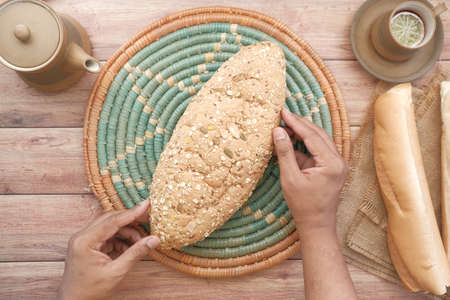 top view of whole grain baked bread and tea cup on tableの写真素材
