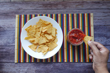 a bowl of chips and salsa on table ,