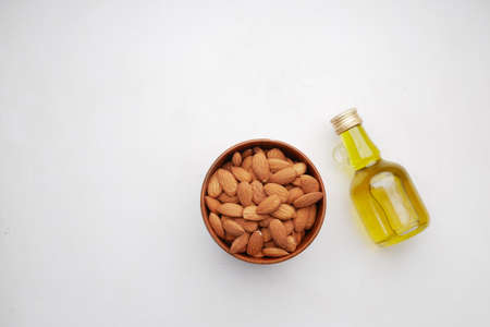 Almond oil in bottle on wooden background.の写真素材