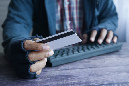 hacker hand stealing data from credit card