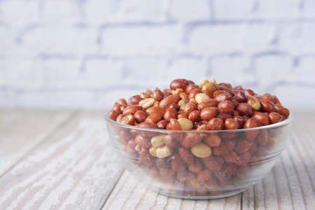 Processed pea nuts in a bowl on table top down .の写真素材