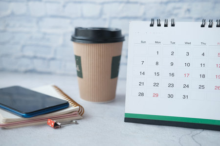 calendar, notepad and smart phone on office deskの写真素材