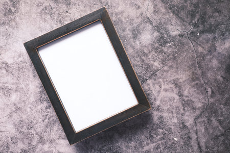 top view of empty frame on wooden background