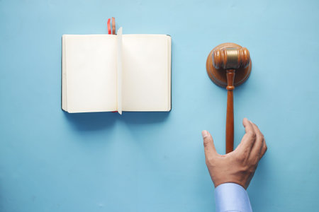 close up of persons hand striking the gavel.