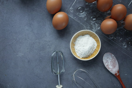 Baking ingredients on a black background, top view.
