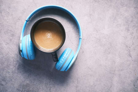 top view of coffee mug and headphone on black background .の写真素材