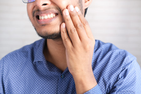 young man with sensitive teeth close up