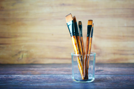 many art brush in a glass on table with copy space