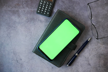top view of smart phone and notepad on table