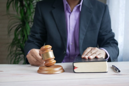 close up of persons hand striking the gavel.の写真素材