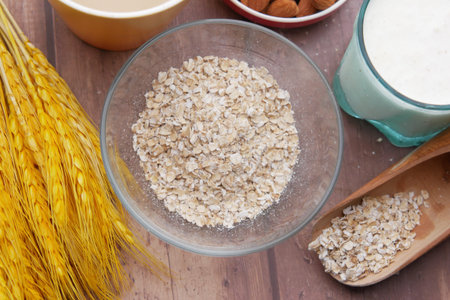 uncooked oats flakes black background, top down
