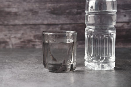 fresh drinking water in a plastic bottle on pink