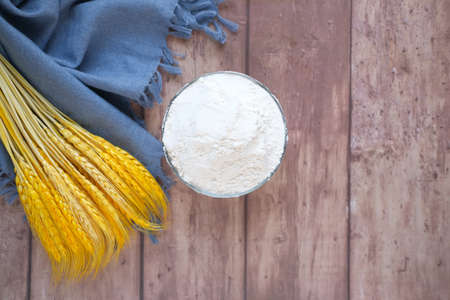wheat flour and spikelets on table with copy spaceの写真素材