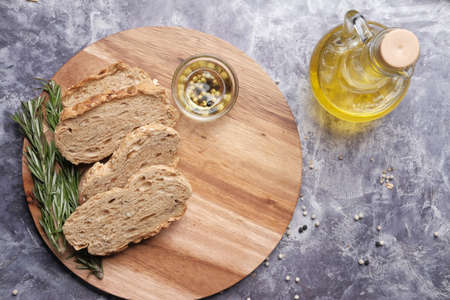 slice of whole meal bread and olive oil on tableの写真素材