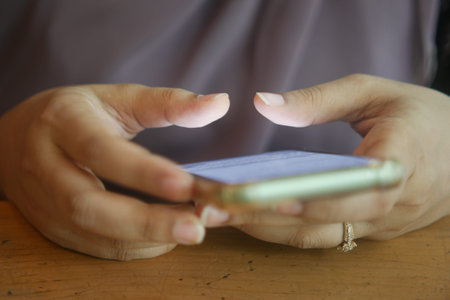 close up of women hand holding smart phone