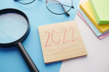 writing 2020 new year goals on s notepad and stationary on tableの写真素材