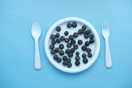 fresh blue berry on a plate on blue background