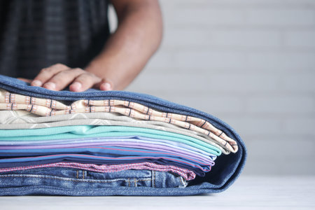 close up of stack of clothes on table .