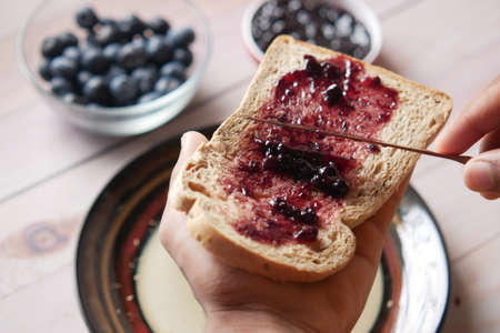 blue berry jam on bread on table,の写真素材