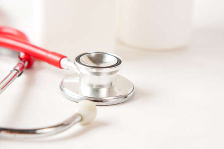 stethoscope and pills container on wooden backgroundの写真素材