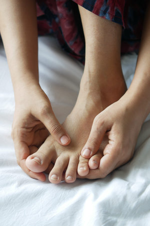 Close up on women feet and hand massage on injury spot.