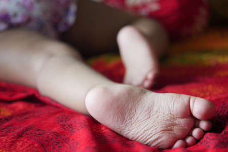 close up of dry child feet on bed ,の写真素材