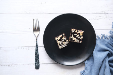 slice of brownie on plate on tableの写真素材